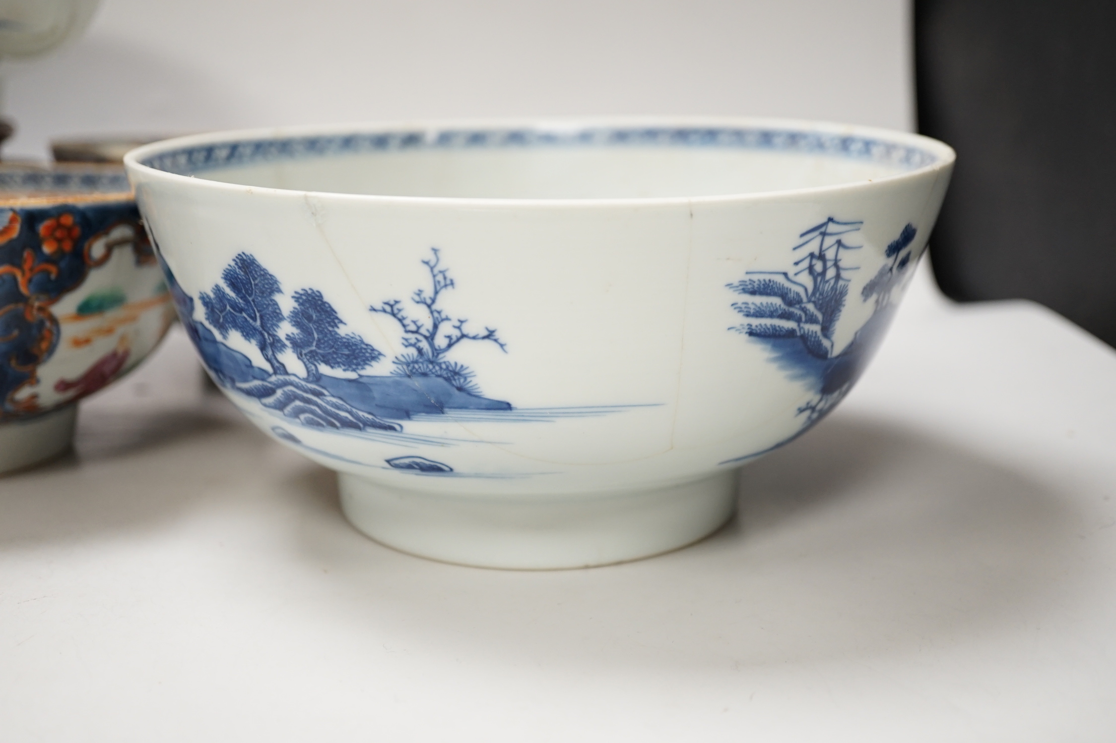 Four 18th century Chinese porcelain bowls (a.f), one with hardwood stand, largest 28cm diameter